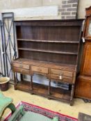 An 18th century oak potboard dresser with boarded rack, length 170cm, depth 40cm, height 197cm