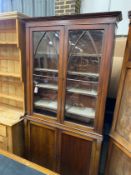An early Victorian mahogany bookcase cupboard, width 105cm, depth 31cm, height 222cm