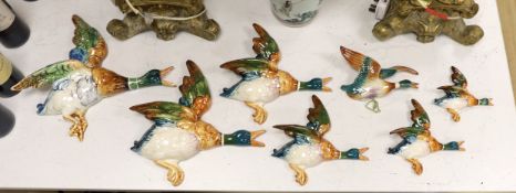 A set of five graduated Beswick porcelain flying ducks and two others by Royal Dux and Shorter.