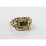 A George IV yellow metal and plaited hair set mourning ring, the ring head verso engraved 'In Memory