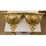 A pair of gilt wood wall brackets