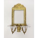 A decorative two branch ormolu wall mirror, lacking the mirror inset. 39cm tall overall, 16.5 x 11.
