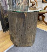 A tree trunk section glass top occasional table, diameter 66cm, height 62cm
