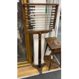 An early 20th century Educational Supply Co. beech classroom abacus on cast iron triangular