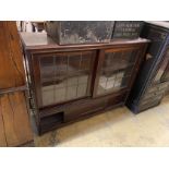 An early 20th century mahogany bookcase enclosed by two sliding leaded glazed doors, length 124cm,