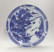A 19th century Chinese blue and white landscape dish. 38cm diameter