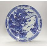 A 19th century Chinese blue and white landscape dish. 38cm diameter