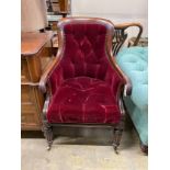 A Regency mahogany bergere chair now upholstered in a deep buttoned red fabric, width 59cm, depth