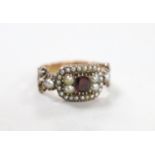 A 19th century yellow metal, foil backed? garnet and split pearl set ring (repair), size O/P,