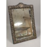 A late Victorian repousse silver mounted dressing table mirror, Henry Matthews, Chester, 1900, 48.