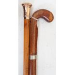 A yellow metal overlay topped walking stick, 91cms long and another (2)