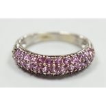 A modern 18ct white gold and pink stone cluster set half hoop ring, size J, gross weight 4.2 grams.