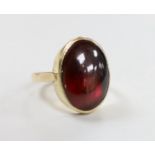 A 9ct and foil backed? oval cabochon garnet set ring, size O, gross weight 5.2 grams.