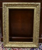 An 18th century French gilt carved wood picture frame, the aperture 51 x 38cm