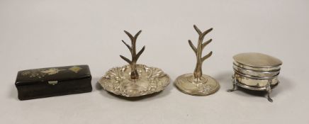 Two early 20th century silver ring stands, tallest 7cm, a small silver mounted trinket box and a