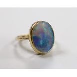 A 9ct and oval black opal set ring, size O, gross weight 4.3 grams.