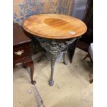 A painted cast iron Britannia pub table with circular mahogany top, diameter 68cm, height 76cm