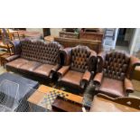A Victorian style button brown leather three piece suite