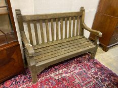 A weathered teak slatted garden bench, length 136cm, depth 58cm, height 100cm