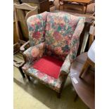 A floral upholstered Georgian style wing armchair (in need of recovering), width 79cm, depth 55cm,