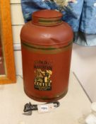 A large toleware tin coffee canister and a novelty iron can opener, canister 38cms high