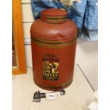 A large toleware tin coffee canister and a novelty iron can opener, canister 38cms high