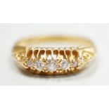 An early 20th century 18ct gold and graduated five stone diamond chip set ring, size L, gross weight
