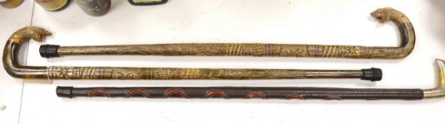Three ornamental walking sticks. Largest 93cm tall