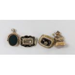 Two Victorian yellow metal and split pearl set mourning brooches, one with black enamel and