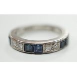 A modern 18ct white gold, six stone sapphire and four stone diamond set half eternity ring, size