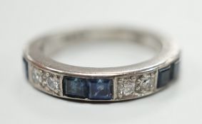 A modern 18ct white gold, six stone sapphire and four stone diamond set half eternity ring, size