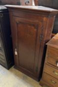 A George III oak hanging corner cabinet, width 72cm, depth 45cm, height 116cm