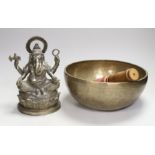 A plated figure of Ganesha and a Tibetan singing bowl with striker