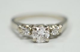 A Canadian Birks 18k white metal and single stone diamond ring, with diamond set shoulders, size