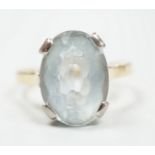 An 18ct and oval cut aquamarine set ring, (shank cut), size P, gross weight 5.3 grams.