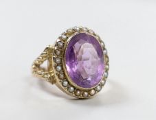 A Victorian style yellow metal, amethyst and seed pearl set oval dress ring, size N/O, gross