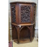 An early 20th century Gothic style carved oak side cabinet, width 118cm, depth 36cm, height 176cm