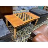 A modern teak hinged top low games table, with backgammon and chess surfaces, width 98cm, depth