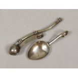 A George V silver caddy spoon and a plated bosun’s whistle.