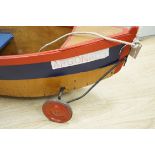 A 1930's Child's pull-along boat, on wheels, 96cms long