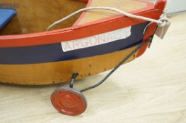 A 1930's Child's pull-along boat, on wheels, 96cms long