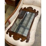 A reproduction 18th century style walnut fret-cut wall mirror, width 48cm, height 91cm