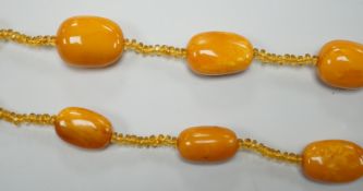 A single strand graduated fifteen amber bead necklace, with multiple amber? spacers, 84cm, gross