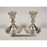 A pair of sterling mounted dwarf candlesticks, 11.9cm and a pair of modern silver compass