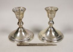 A pair of sterling mounted dwarf candlesticks, 11.9cm and a pair of modern silver compass
