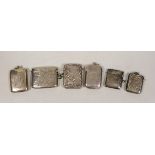 Six assorted mainly early 20th century engraved or engine turned silver vesta cases, largest 52mm.