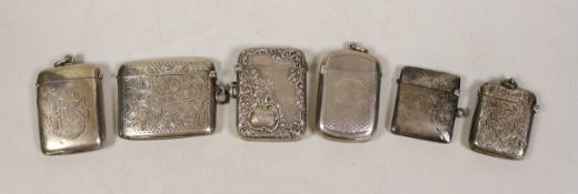 Six assorted mainly early 20th century engraved or engine turned silver vesta cases, largest 52mm.