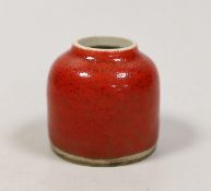 A Chinese red glazed brushwasher. 6cm tall