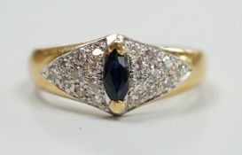 A modern 18ct gold and single stone marquise cut sapphire set dress ring, with pave set diamond