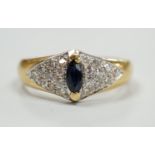 A modern 18ct gold and single stone marquise cut sapphire set dress ring, with pave set diamond